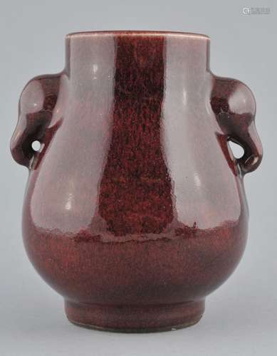 Porcelain vase. China. Late 19th century. Pear shaped with elephant head handles. Lang yao glaze of a deep crushed strawberry colour. 6