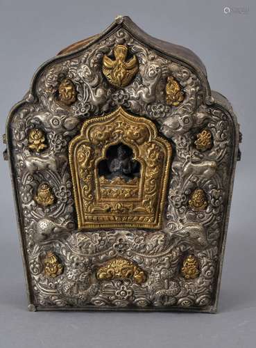 Traveling shrine. Tibet. 19th century to early 20th century. Repousse silver and brass on a copper body. Decoration of mythical animals. 7-1/2