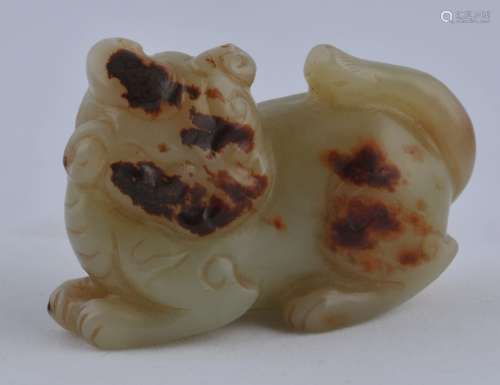 Jade carving. China. 18th century. Yellow green with pronounced russet markings. Study of a lion. 2