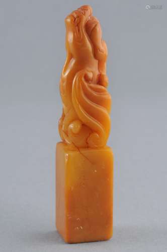 Soapstone seal. China. Early 20th century. Honey colored stone. Finial in the form of a winged dragon. 3-1/2