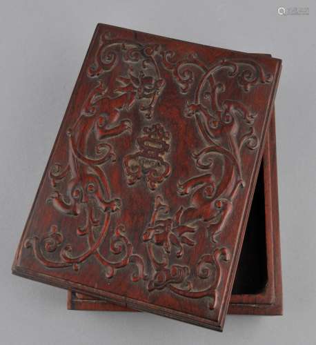 Rosewood box. China. 20th century. Rectangular form. Lid  carved in relief with two Chih Lung with branches of Ling Chih flanking a central Shou character. 7-1/4