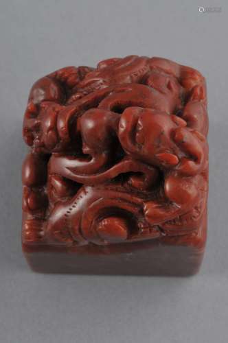 Soapstone seal. China. 19th century. Maroon coloured stone. Finial in the form of a pair of dragons swirling around a celestial pearl. Seal intact. 3