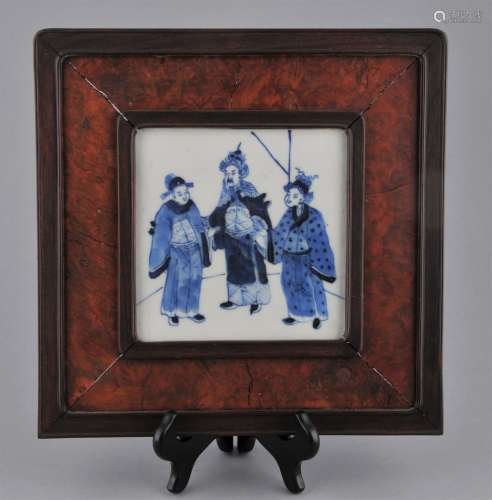 Porcelain Plaque. China. Early 20th century. Underglaze blue decoration of three figures. Rosewood and burl wood frame. 10-1/2