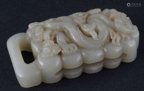 Jade buckle. China. Yuan style and possibly of the period. Stone of a grey color.  Carved and pierced decoration of a dragon, pearl and clouds. 3