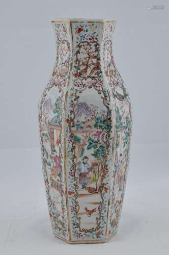 Porcelain vase. Chinese Export ware. 18th century. Hexagonal form. Floral borders with reserves of mandarins, women and children in garden scenes. 11-1/2