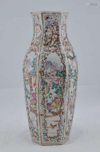 Porcelain vase. Chinese Export ware. 18th century. Hexagonal form. Floral borders with reserves of mandarins, women and children in garden scenes. 11-1/2