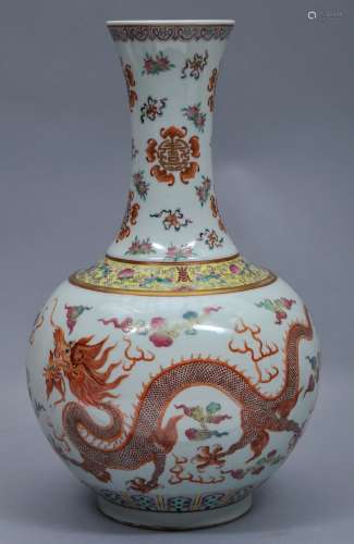 Porcelain vase. China. Hsuan Tung mark (1908-1912) and of the period. Decoration of dragons and phoenixes, neck decorated with bats, peaches and shou medallions. 15