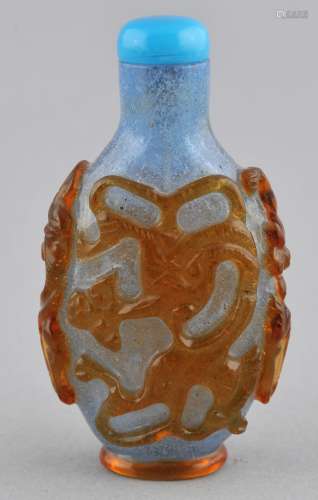 Snuff bottle. China. 19th century. Cameo glass. Yellow cut to blue snowflake. Carving of Chih Lung. 2-3/4