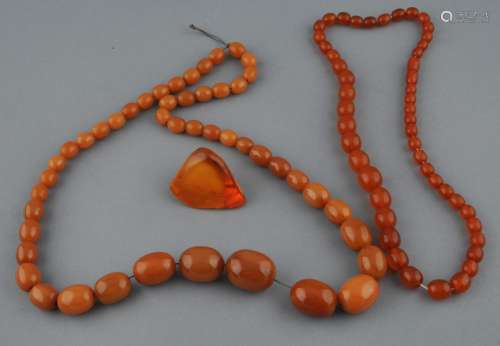Lot of amber. To include: Two necklaces and a polished specimen.