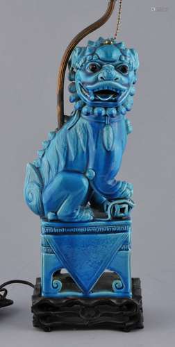 Porcelain foo dog. China. Late 19th century. Turquoise glaze. Fitted wooden stand. Mounted as a lamp. Figure- 14