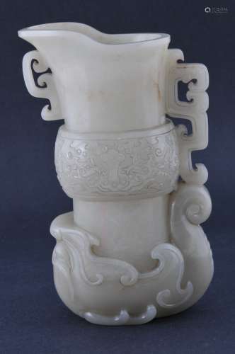 Jade ewer. China. Early 20th century. Uniform highly translucent grey stone. Carved as an archaic ritual vessel. Kuang with a hand of phoenix scrolls emerging from the mouth of a mythical animal.  7