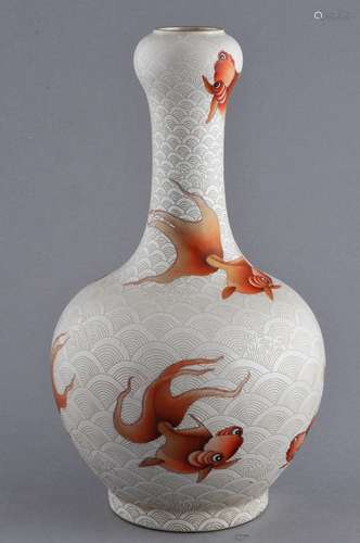 Porcelain vase. China. 20th century. Garlic mouth top. Iron red decoration of goldfish on a carved white wave ground. Tao Kuang mark on the base.  10-1/2