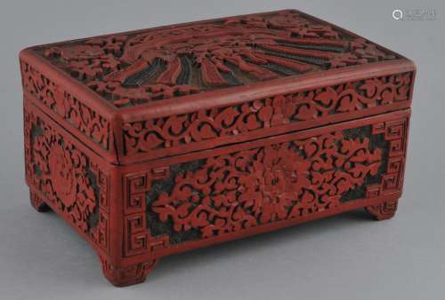 Cinnabar box. China. 19th century. Rectangular form. Three-colour carved decoration of a basket of auspicious emblems with borders of flowers. 6-1/4