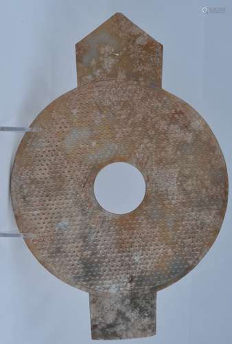 Archaic Ritual Jade. China. Han style. Pi Kuei form. Much calcified stone with traces of ochre. Pi surface carved with a grain pattern. 11-1/2