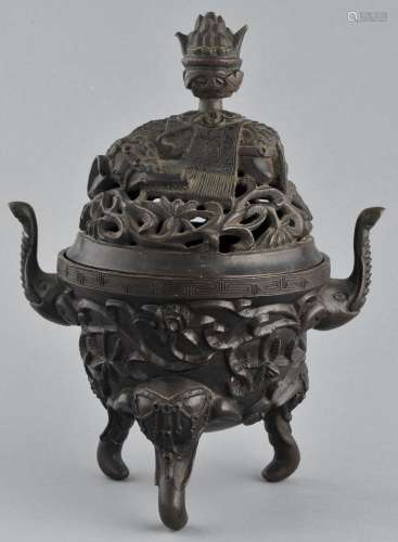 Bronze censer. China. 19th century. Elephant shaped handles and tripod base. Foliate decoration to the body. Elephant finial on the lid. 9