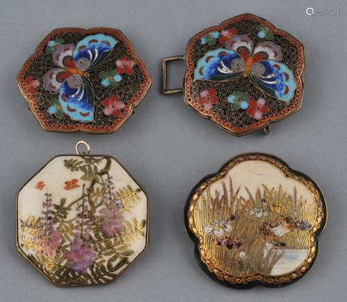 Lot of two sets of belt buckles. Japan. Meiji period (1868-1912). One of Cloisonné with decoration of butterflies. The other inset with Satsuma panels decorated with wisteria. Each 2