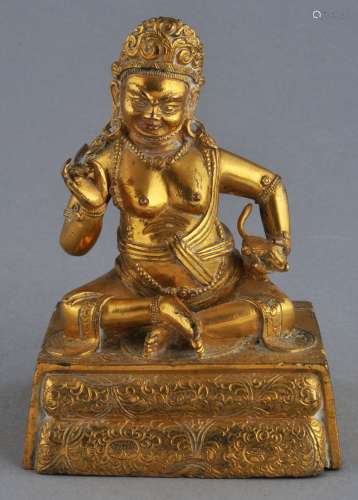 Gilt bronze Buddhist image. Tibet. 18th century figure of Kubera the God of Wealth seated on an engraved throne. 4