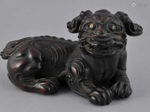 Rosewood carving. China. 19th century. Study of a Foo Dog with inlaid eyes. Loss to a section of the tail. 3