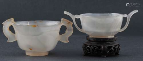 Two agate cups. China. 19th century. Highly translucent grey stone. One with russet markings. Both with handles. (fissures to one). Each about 3