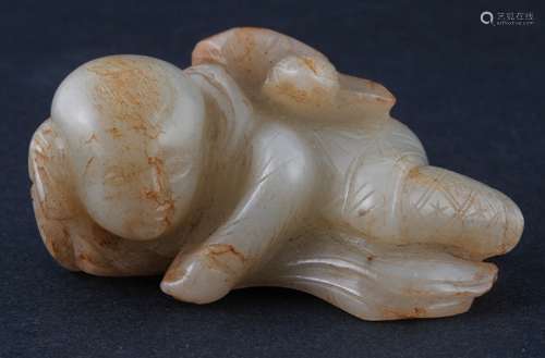 Jade carving. China. Probably Ming period. Yellow white stone with russet markings. Carving of a reclining child with a lotus plant. 2-1/2