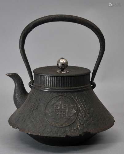 Iron kettle. Japan. 19th century. Testsubin with cast decoration. Silver finial and spout rim. 8