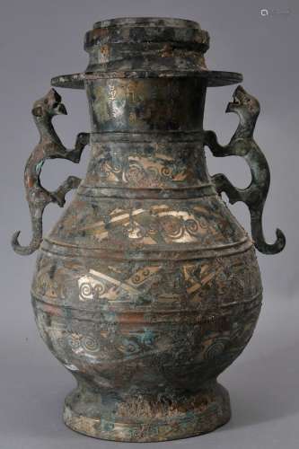 Bronze wine jar and cover. China. 20th century. Huai style. Animal form handles. Surface inlaid. Approx. 12