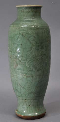 Celadon vase. China. Yuan period. (1279-1368). Lung Chuan ware. Surface carved with flowers. Bright sea green glaze. Repair to the drill hole where it was mounted as a lamp. 12