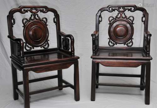 Pair of Armchairs. China. 19th century. Rosewood. Back splats and sides carved and inset with roundels. 24-1/2