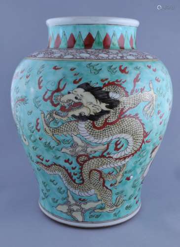 Porcelain vase. China. 19th century. Baluster form. Famille Verte decoration of dragons and phoenixes on a pale green ground. 14-1/2