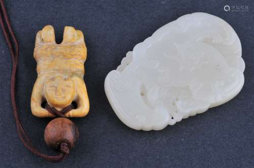 Lot of two Jade carvings. China. To include: An 18th century jade pendant carved with archaic scrolling. 2-1/2