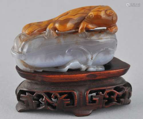 Agate carving. China. 19th century. Blue grey and brown stone. Carving of a squirrel and a melon. Fitted rosewood stand. 2