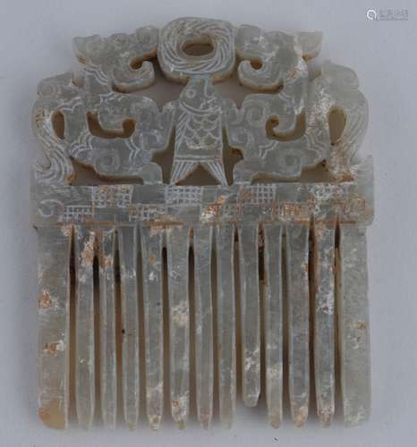 Jade comb. China. Probably Chou period. Grey stone areas of calcification. Finial of two dragons flanking a fish. 2-1/4