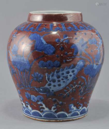 Porcelain vase. China. 20th century. Underglaze blue decoration of fish and aquatic plants on a red ground. Chia Ching mark. 7