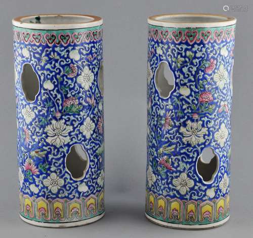 Pair of porcelain hat stands. China. Early 20th. Decoration of insects and lotus scrolling on a deep blue ground. 11