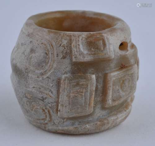 Jade ring. China. Chou style. Barrel form with squared bosses in the form of a human vase. 1-1/2