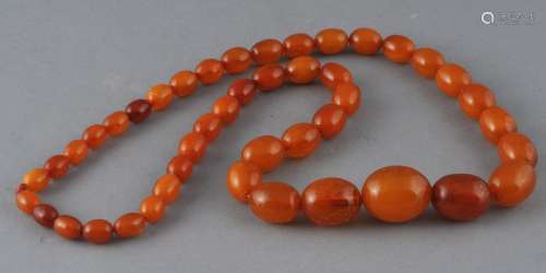 Set of graduated amber beads. Honey colored.