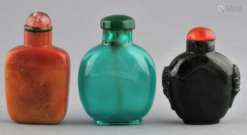 Lot of three Snuff Bottles. China. Two 19th century bottles, one of soapstone carved with flowers. One of green glass the other of forest green jade. Tallest- 2-1/2