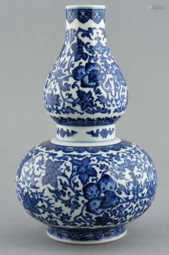 Porcelain vase. China. 20th century. Double gourd form. Underglaze blue decoration of peaches and foliage. Ch'ien Lung mark. 11