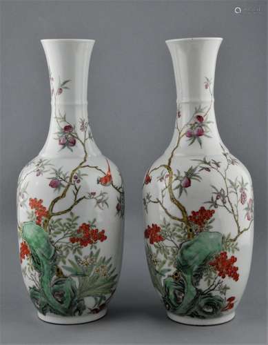 Pair of porcelain vases. China. Early 20th century. Bottle form. Famille Rose decoration of birds, peach trees and berries. 14