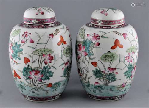 Pair of porcelain covered jars. China. Early 20th century. Famille Rose decoration of egrets and lotus plants. 11-1/2