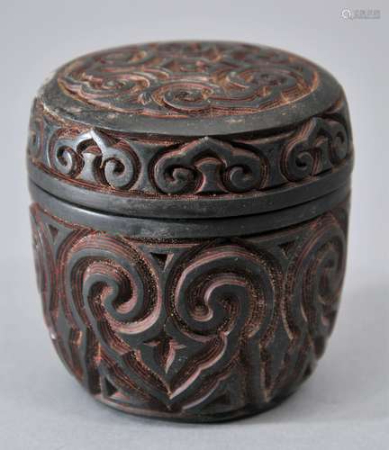 Lacquered box and cover. China. 19th century Gure ware. Black and red carved with ju-i patterns. 2-1/2