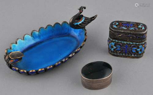 Lot of three metal works. China. 19th/20th century. To include: A silver box set with bloodstone, an enameled silver filigree box and an ashtray in the shape of a peacock.