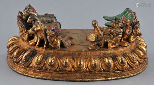 Gilt Bronze base for a Buddhist image. Tibet. 19th century. Decoration of horses, cattle, birds and various divinities. 8