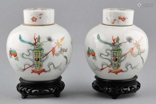 Pair of porcelain covered jars. China. Early 20th century. Famille Rose decoration of 