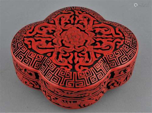 Cinnabar lacquer box. China. 20th century. Quatrefoil form. Decoration of dragons and flowers. 6