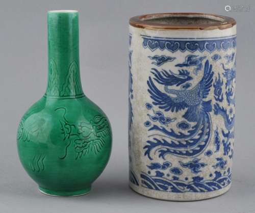 Lot of two porcelains. China. 20th century. A bottle shaped vase engraved with a dragon beneath a green glaze and a brush pot with dragons and phoenixes.