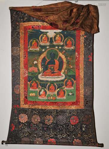 Buddhist Icon Thangka. Tibet. 19th century. Distemper on heavy cloth. Image of the Medicine Buddha surrounded by Lineage figures. 25