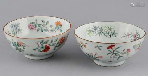 Pair of porcelain bowls. China. Ch'ia Ching mark (1796-1820) and period. Famille Rose decoration of butterflies and flowers. Both with hairlines and rim chips.