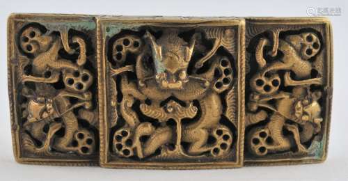 Bronze belt buckle. China. 19th century. Cast with a central dragon and two flanking dragons. 3