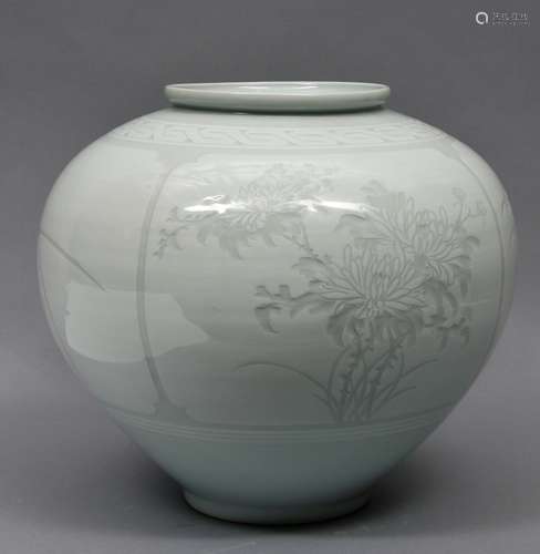 Porcelain jar. Korea. 20th century. Pale celadon glaze. Surface  carved with bamboo and flowers. 14-1/2